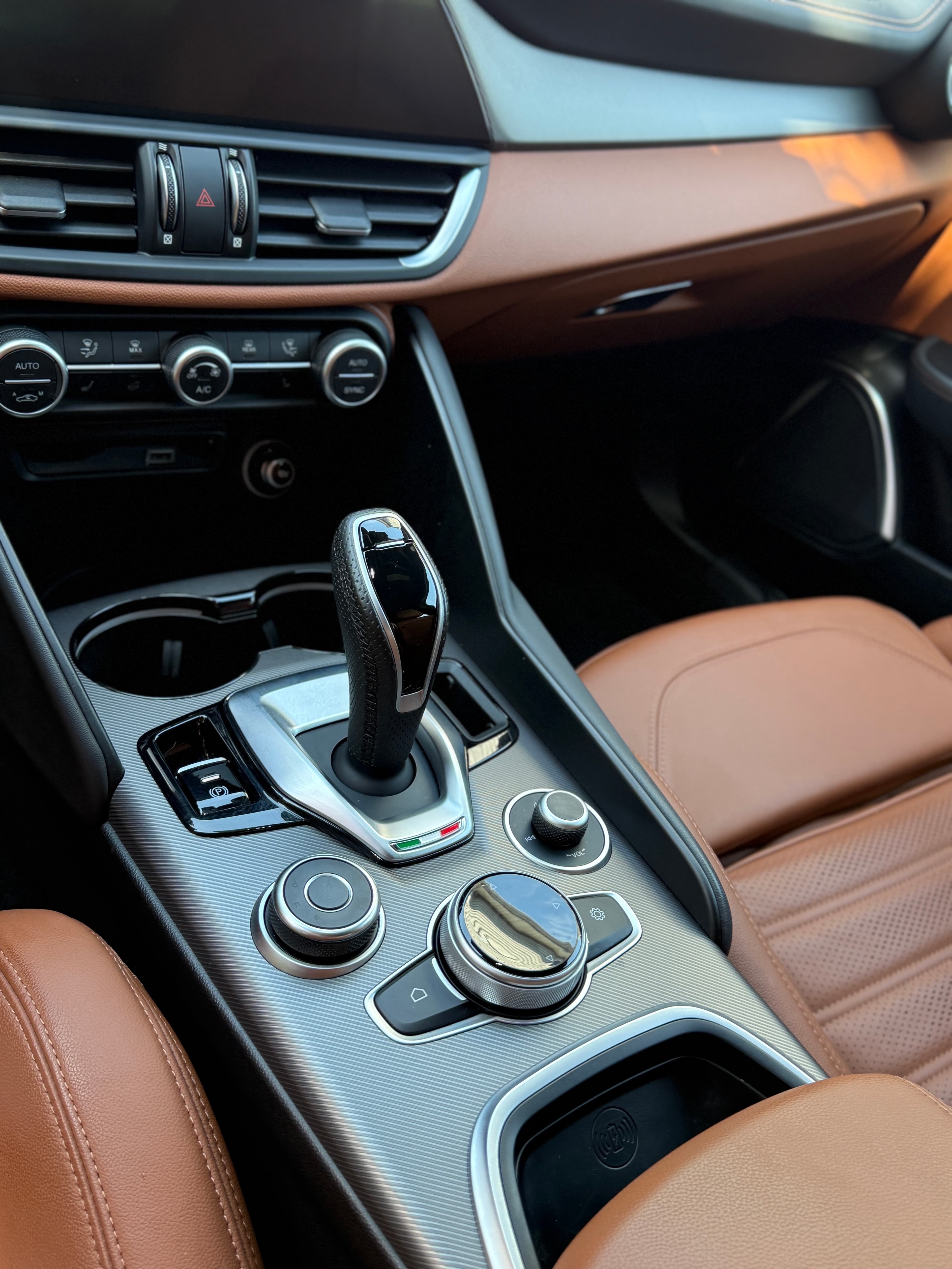 Brown leather seats and center console of an Alfa Romeo Giulia deep cleaned in Demarest
